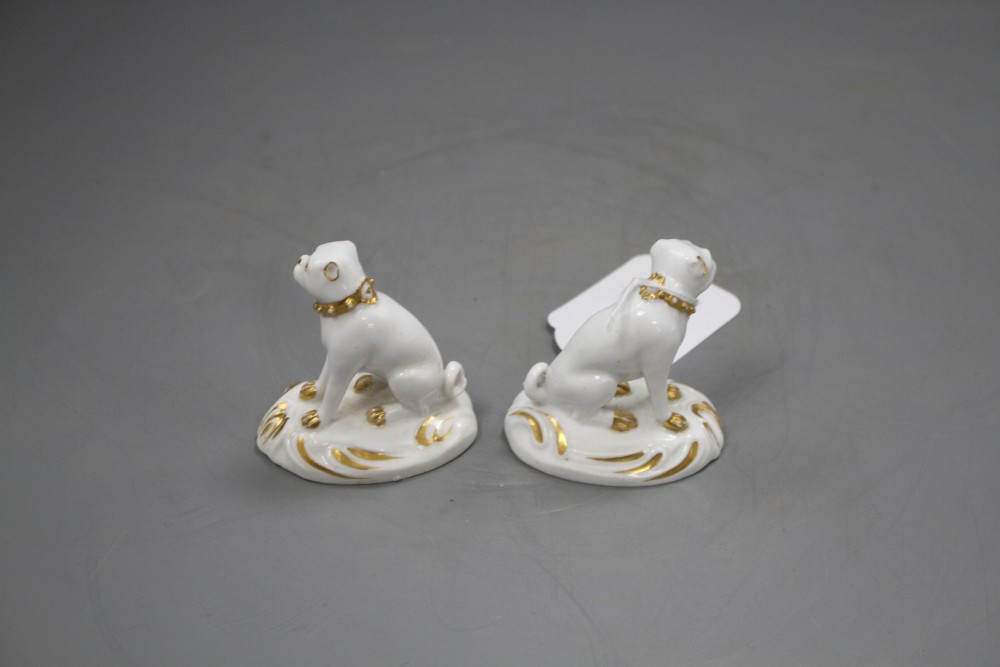 A pair of Derby gilt and white seated figures of pug dogs, c.1830, H. 5.7cm